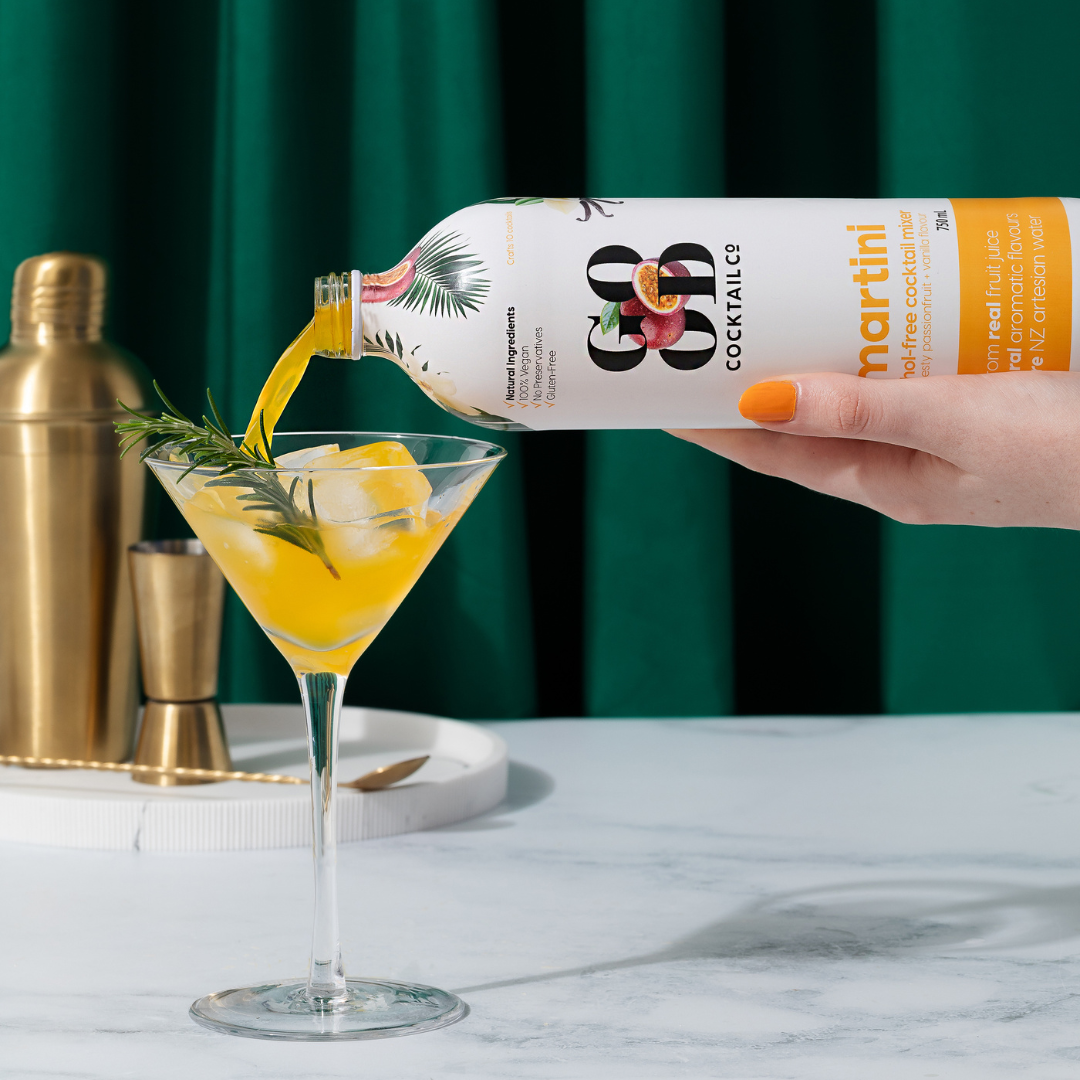 Martini cocktail mixer being poured into cocktail glass