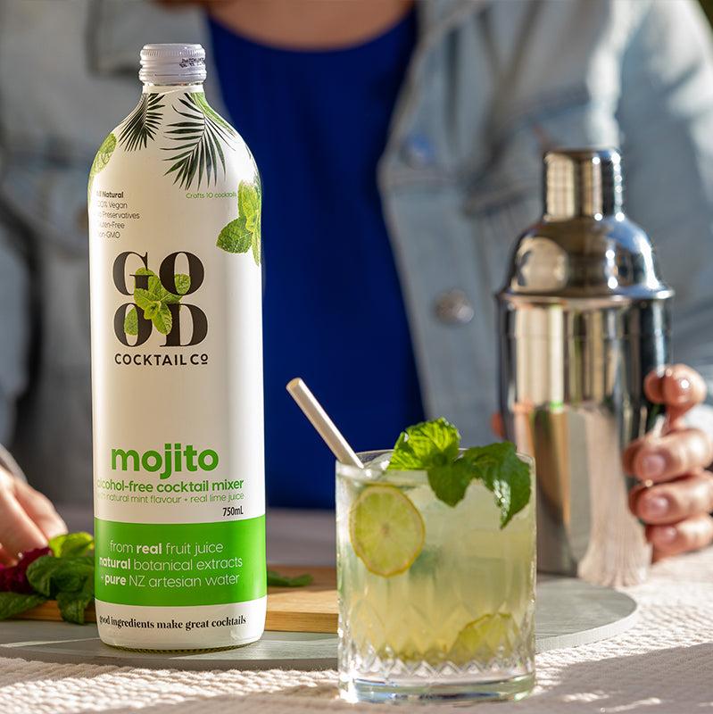 Mojito cocktail mixer in bottle and mojito cocktail in a glass next to it