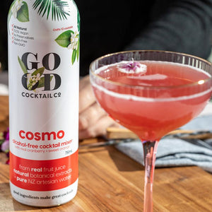 Cosmo cocktail in glass and bottle of Cosmo mixer