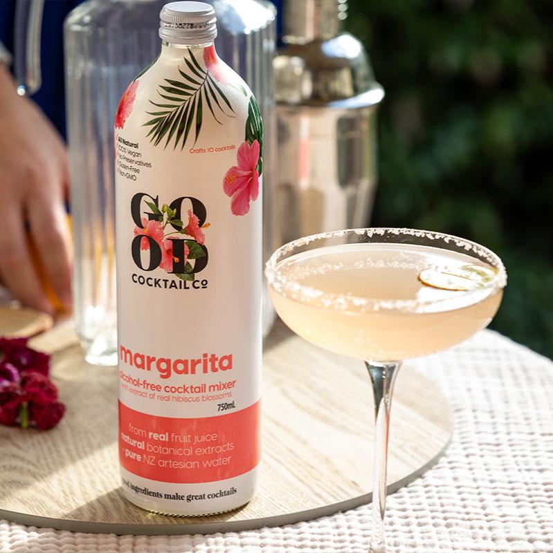 Margarita cocktail mixer in bottle next to cocktail in glass