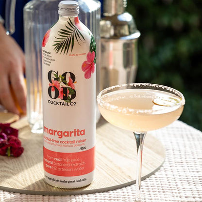Margarita cocktail mixer in bottle next to cocktail in glass