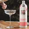 Margarita cocktail mixer next to empty cocktail glass